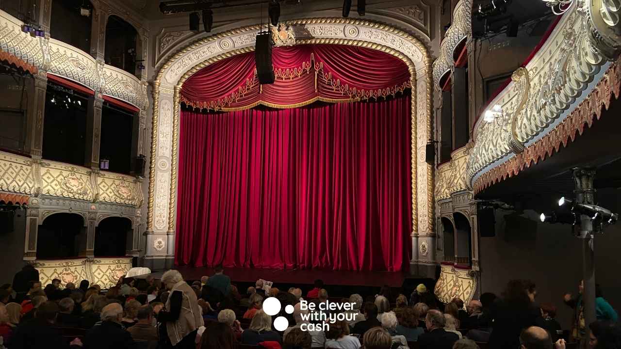 a theatre curtain with the be clever with your cash logo
