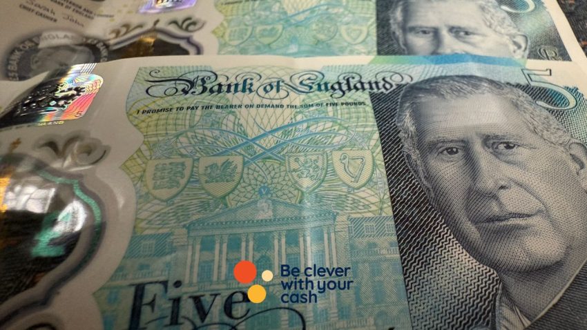 A close up of two five pound notes