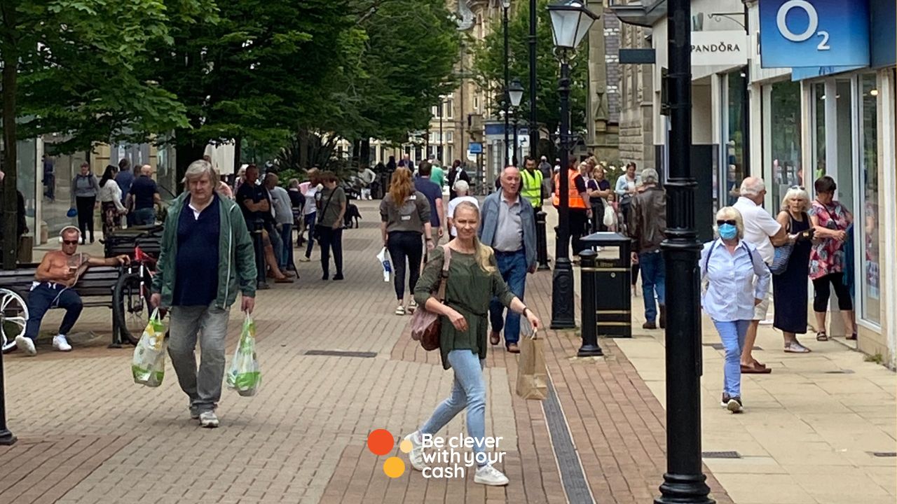A high street and people with shopping bags